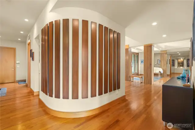 This home is rich with custom accents and architecture at every turn. The garage is through the door shown to the left and just before that is the laundry room.