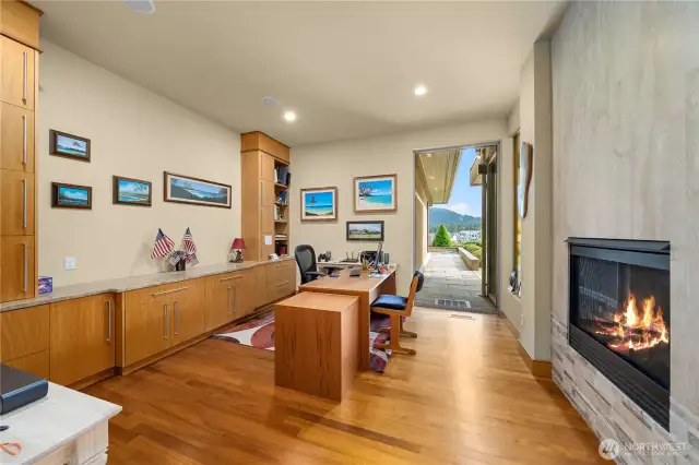 Now this is what a home office should be, offering a relaxing ambiance, an abundance of cabinetry and its own gas fireplace.