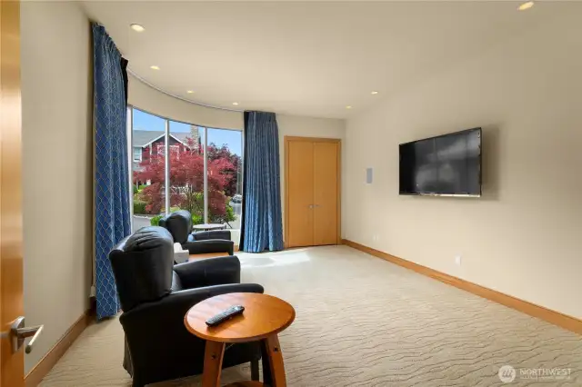 This bonus/media room also has sweeping rounded floor-to-ceiling windows and could be a serene retreat, a game room, or whatever your vision for it is.