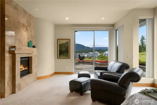 Inviting sitting area in the primary suite, the perfect place to curl up and enjoy the fire, or watch the sky blaze when the sunsets are glorious.