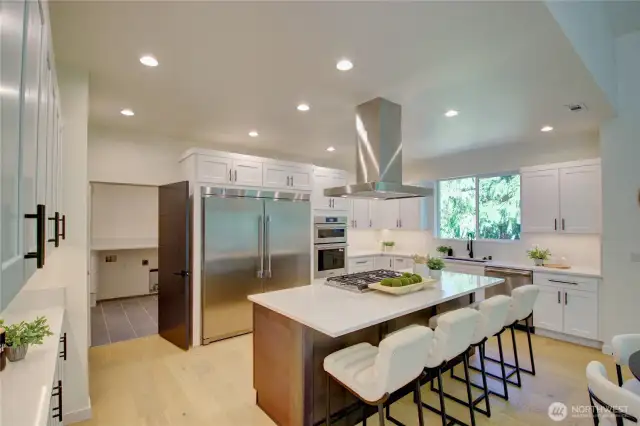 This kitchen has a double refrigerator and pantry.