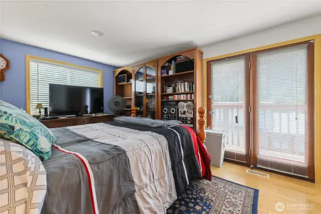 Master bedroom with French doors leading to a deck
