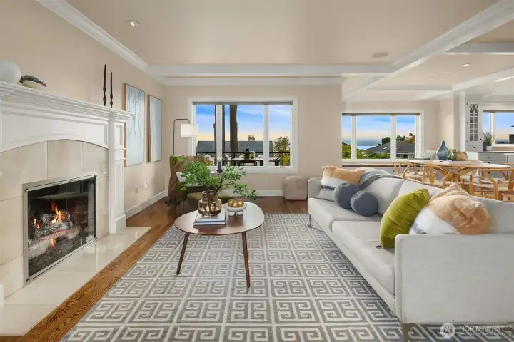 As you step inside to the left of the entry, you're drawn into the inviting living room with gas fireplace and first glimpses of the water and mountain views to come.