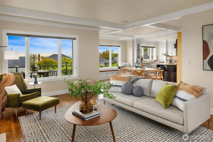 The living room has just enough separation to be its own space, while still feeling very much connected to dining, kitchen, and back view deck.