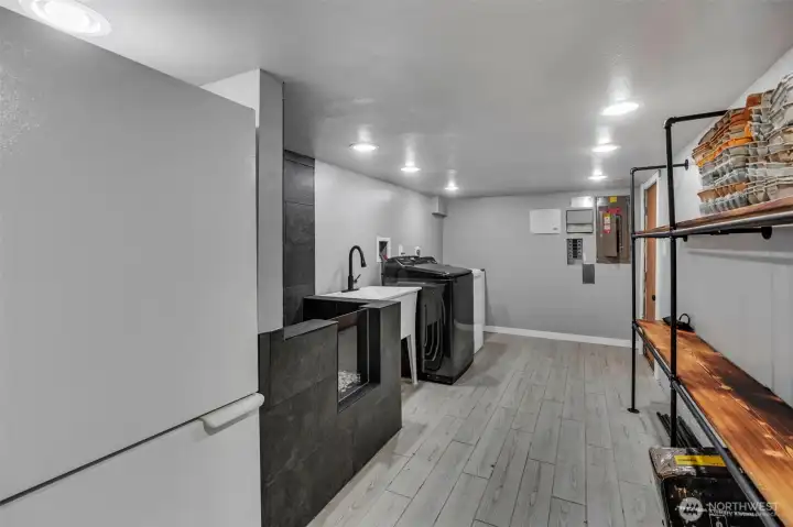 Huge laundry/utility room complete with convenient dog shower, refrigerator/freezer, laundry tub and loads of storage space.