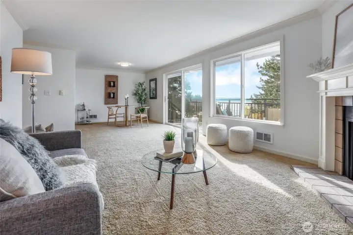 Living Room Opens to Dining Room and Private Deck offering breathtaking Lake and City Skyline views.
