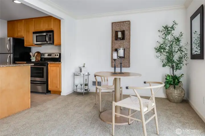 Elegant Dining Room with wainscotting that opens to the kitchen.