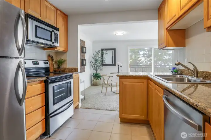 Chef's kitchen with Granite Countertops and Stainless-Steel Appliances.