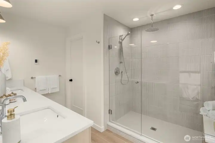 Spa-inspired primary bath with heated floors and thoughtfully selected tile.