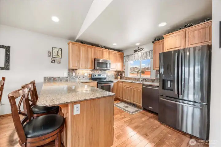 Kitchen bar and stainless steel appliances.