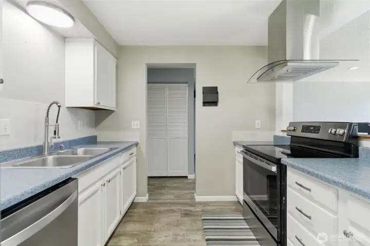 Efficient kitchen with newer vent hood open to the main living space. Efficient kitchen with newer vent hood open to the main living space.