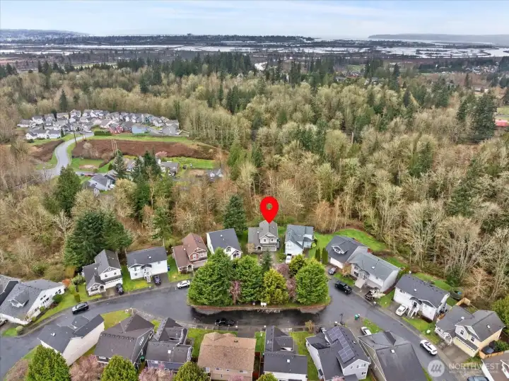 Aerial view of the home and neighborhood looking westward.