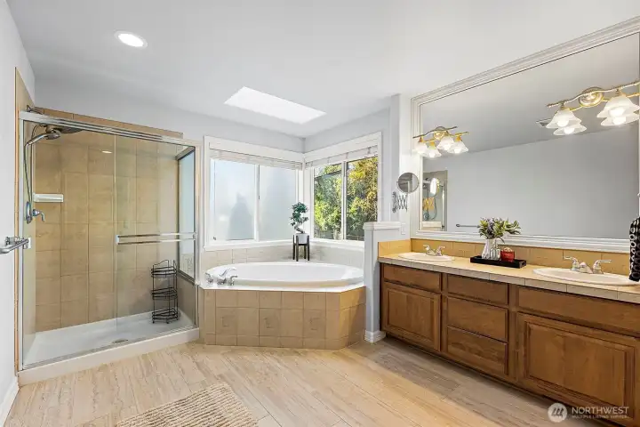 Spa-like primary bath with dual walk-in closets