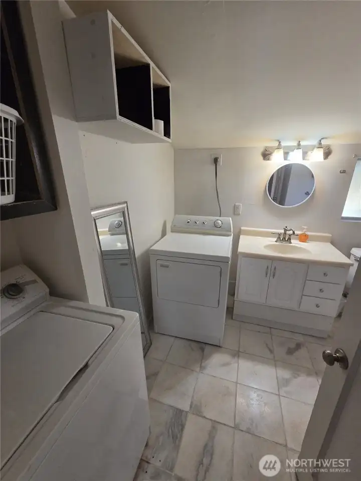 Ok, just past the kitchen is the combination laundry room and bathroom.