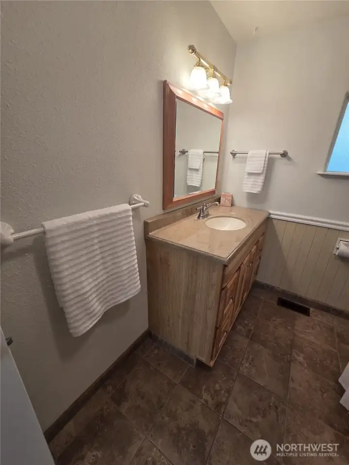 On the right the second bathroom, earth tone tiles.