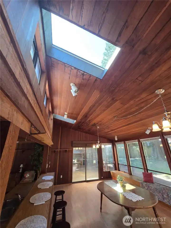 Back in the great room, leading out to the covered deck, you too can laugh at the rain.