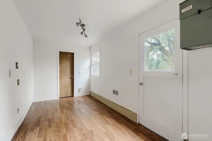 Lower-level office with a closet and a door to the yard. The green box is a central vacuum system.