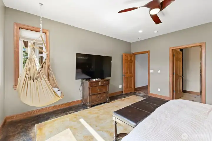Main level Primary bedroom with French doors to the wraparound deck