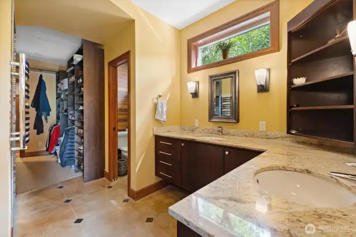 Primary bathroom with dual sink and walk in closet
