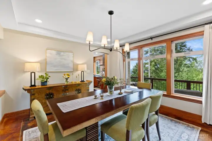 Formal dining room off the kitchen with a wall of windows for natural light and lake views