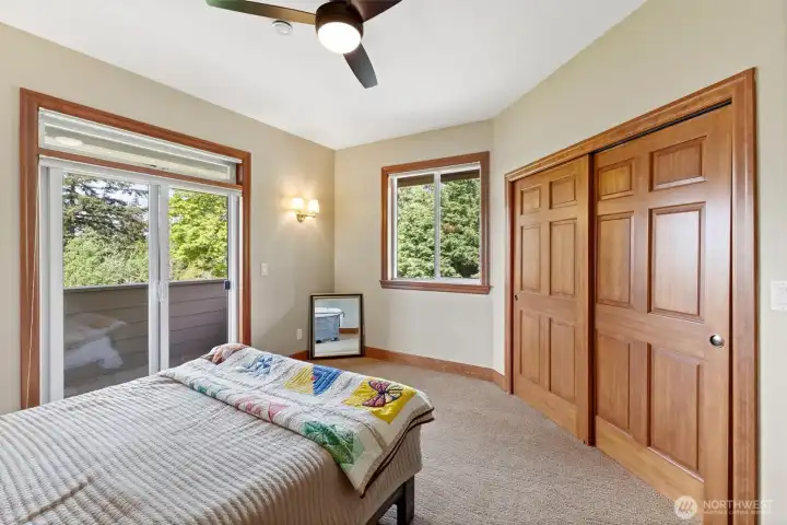 third bedroom upstairs with sliders to the covered patio