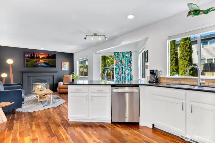The newly refreshed kitchen has granite countertops, newly painted cabinets and overlooks the backyard