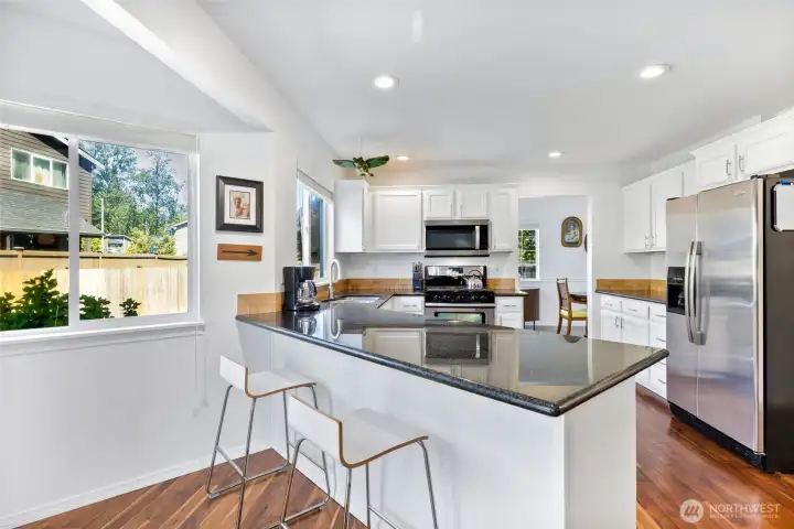 Looking onto the spacious kitchen with tons of light coming in