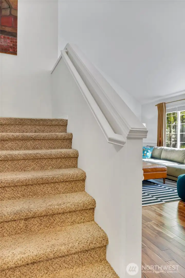 Stairs leading to the three bedrooms
