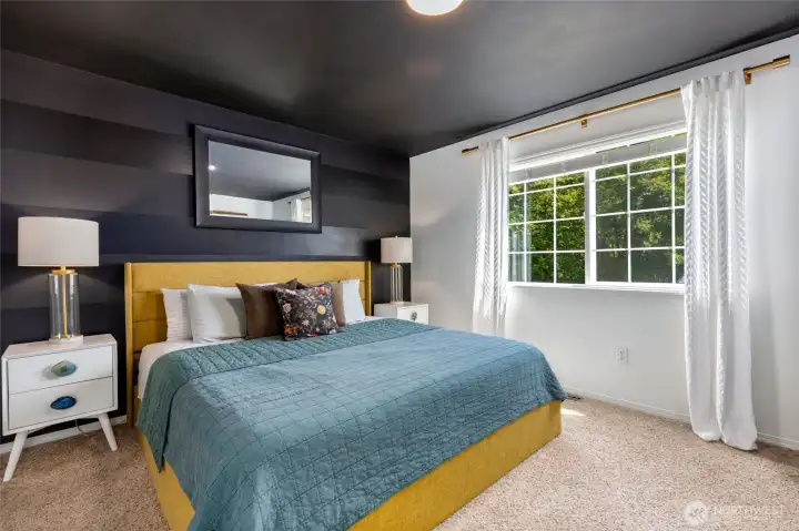 Primary bedroom overlooking the front of the home. This spacious room is beautiful!
