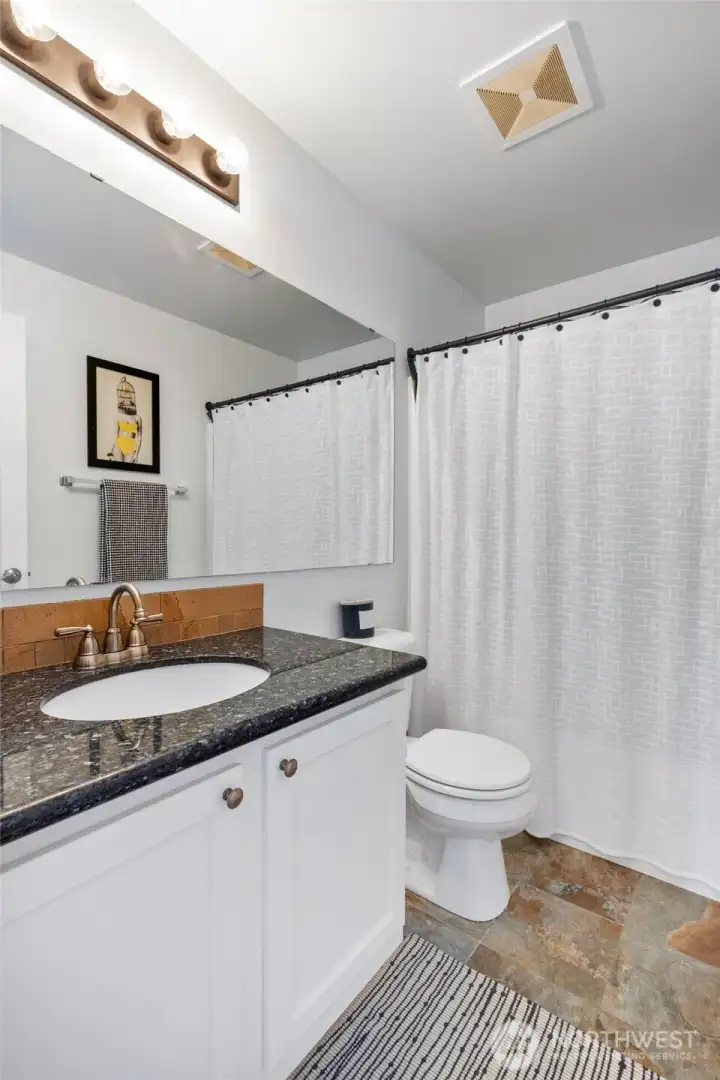 Main bathroom upstairs with granite countertops