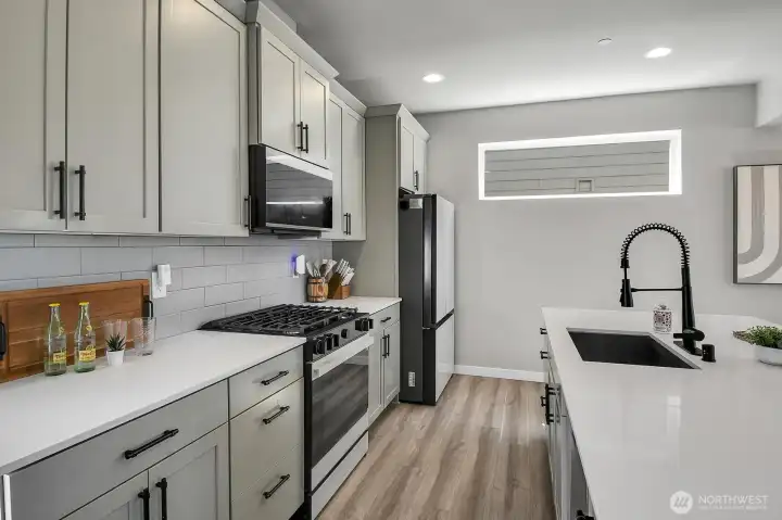 Quartz counter tops, white appliances, and tons of storage.