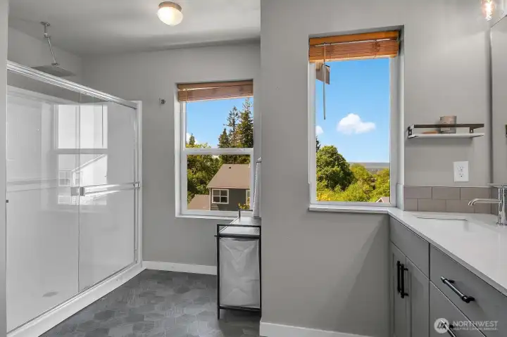 Oversized walk-in shower with rain head shower.