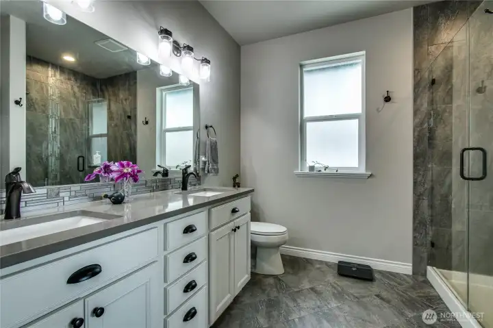 Luxurious primary bath has walk-in closet and walk-in shower
