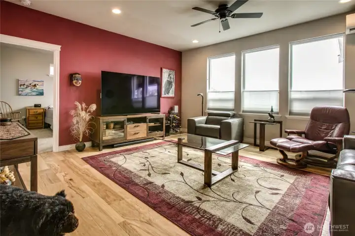 Large central living room w/ bank of south-facing windows