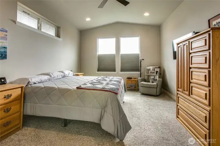 Primary bedroom has sitting space and vaulted ceilings