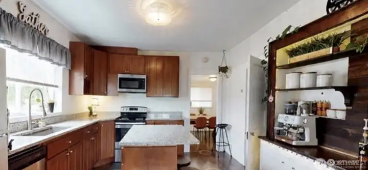 Updated kitchen with cherry cabinets and slab granite counters