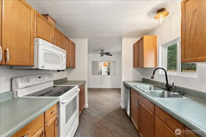 The bright galley kitchen features ample cabinetry and an efficient layout that keeps everything within easy reach.