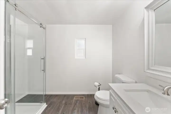 Enjoy a fresh, modern bathroom complete with a sleek walk-in shower and clean, timeless finishes.