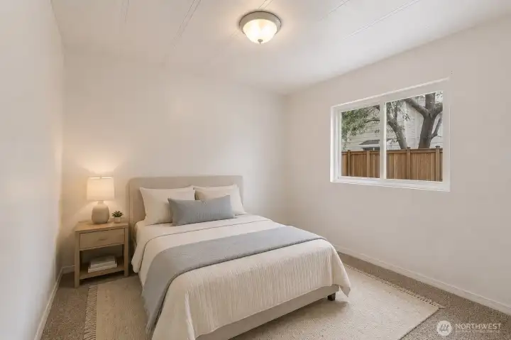 A comfortable secondary bedroom filled with natural light provides a welcoming space for family, guests, or a home office.