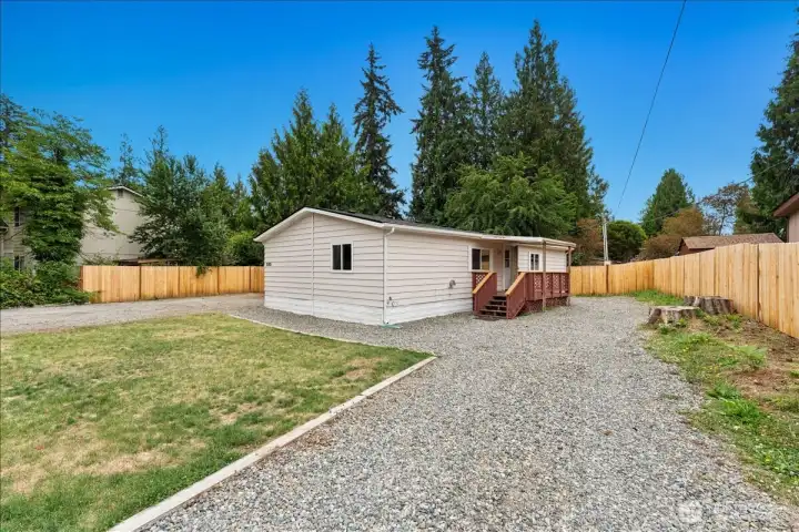 The covered front porch creates a charming spot to unwind while overlooking the peaceful property.