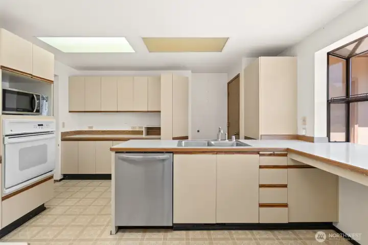 Kitchen with garden window and access to main hallway. Kitchen with garden window and access to main hallway.