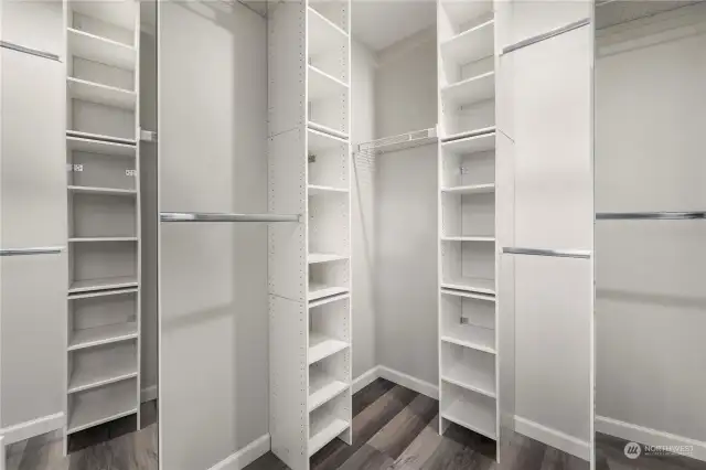 Primary walk-in closet with organizers.