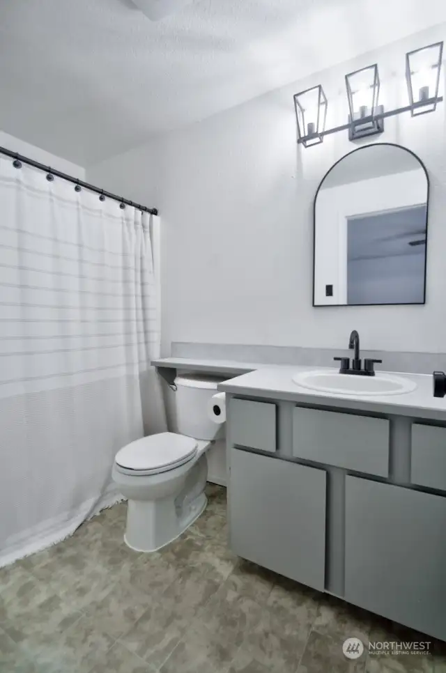 Primary full bathroom - notice the modern, black fixtures