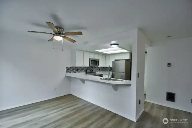 Efficient kitchen with stainless steel appliances and designer backsplash