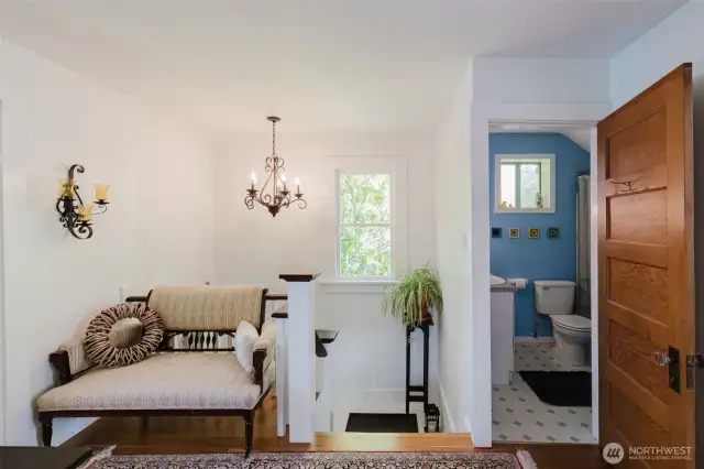 Hallway toward stairs and upstair bath