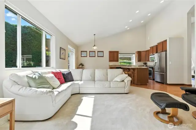 Open concept family room with large windows allows natural light to brighten up the home.