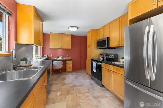 Galley kitchen with updated appliances and lots of cabinets for storage.