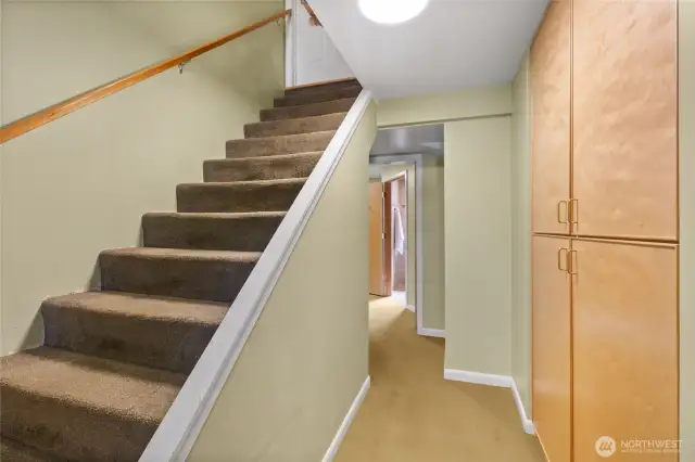 Interior Stairwell that leads to the daylight basement, the garage, laundry, another bathroom and out to the back yard. Check out all of the built in storage to the right.