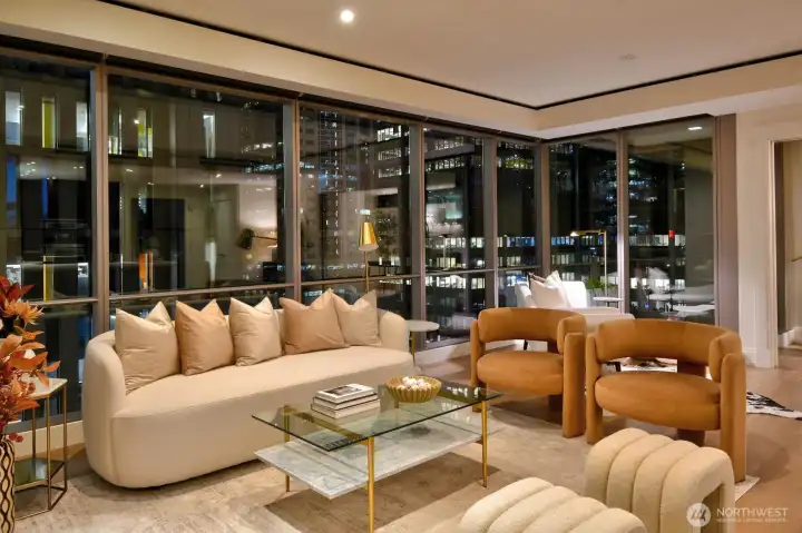 Twilight photo of living room in Unit 1205 with dramatic city light views