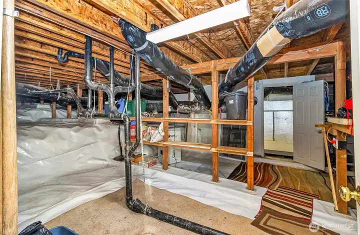 Regular size man-door into  the crawl space. So much storage including a room perfect for extra storage or hobby tinckering.